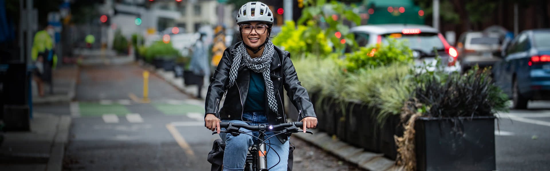 A young woman riding a bike through a city