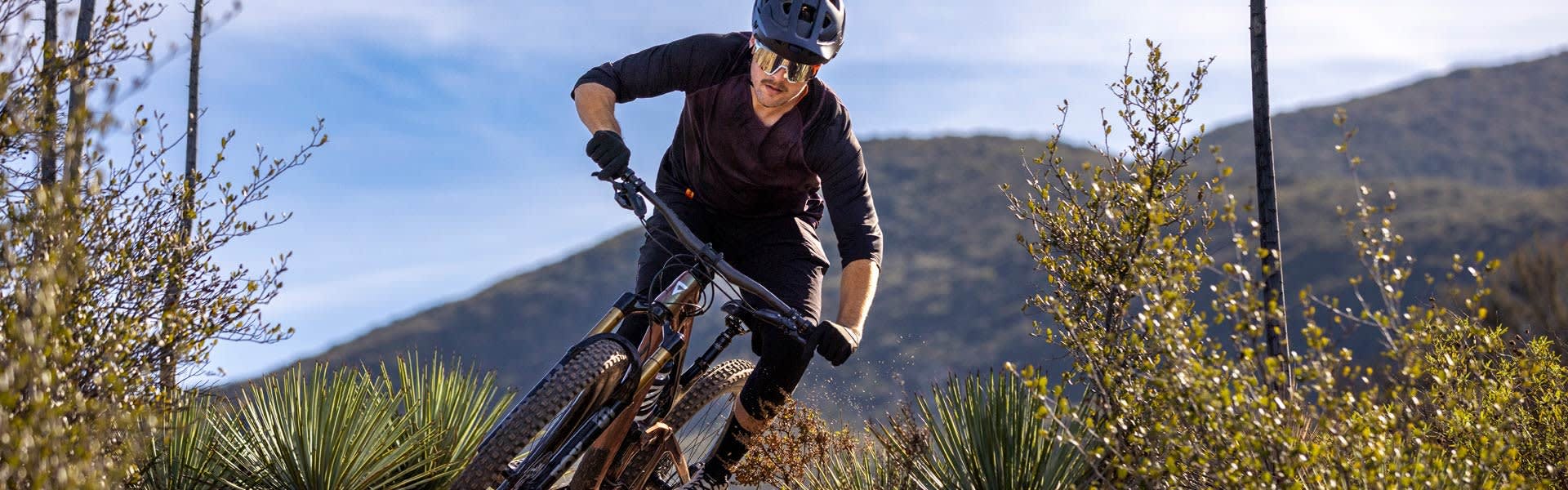 A man riding a bike through rough terrain